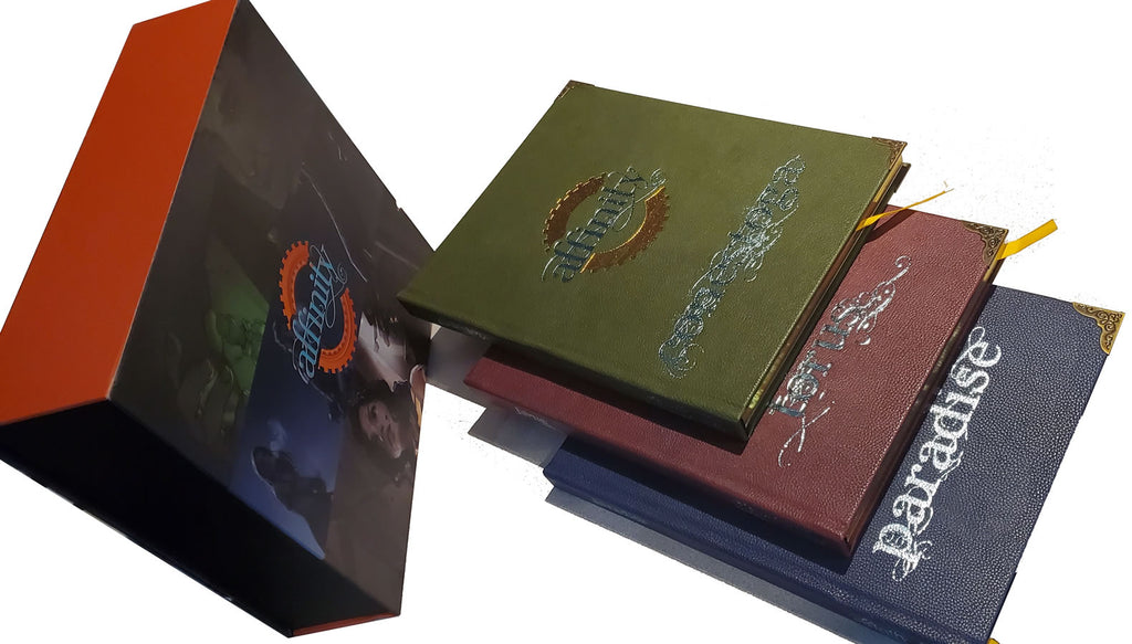 Three leather-bond books that fit into a artistic box.
