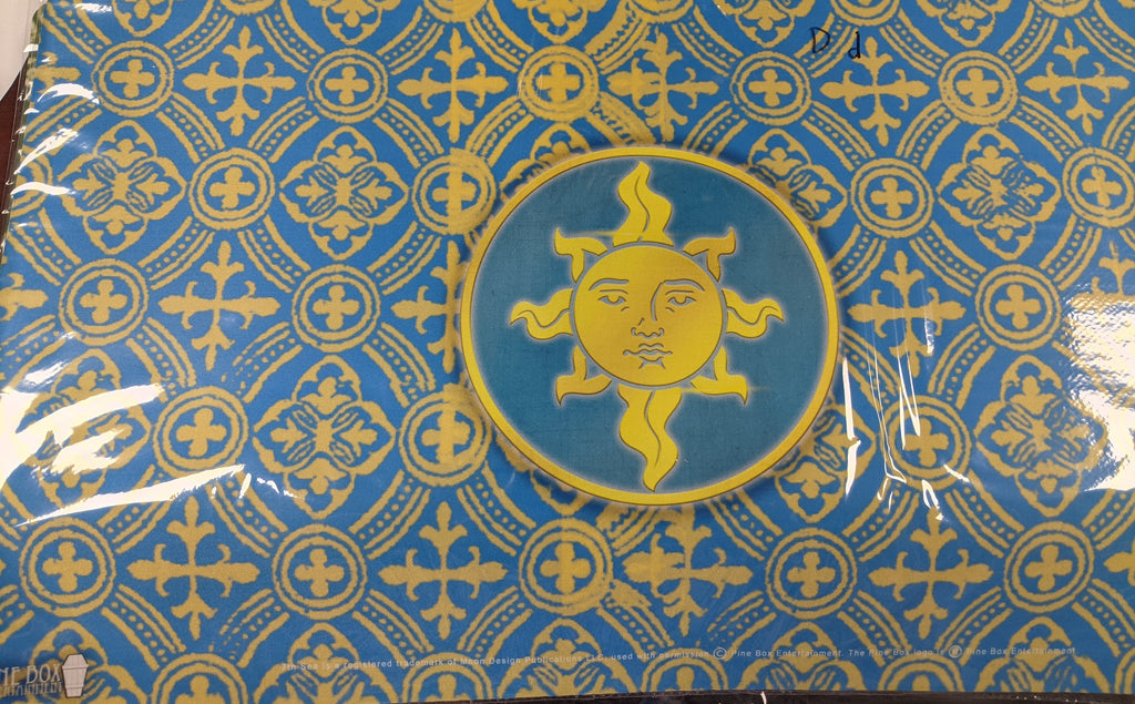 Blue background with yellow design. Center of playmat is a sun logo.