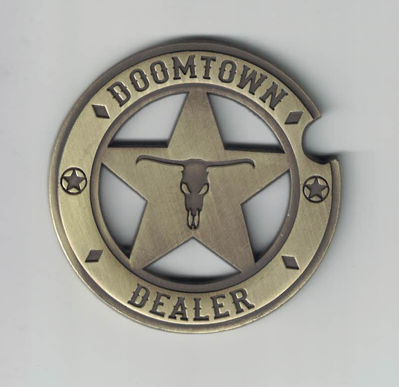 A token that resembles a sheriff's badge "Doomtown Dealer"